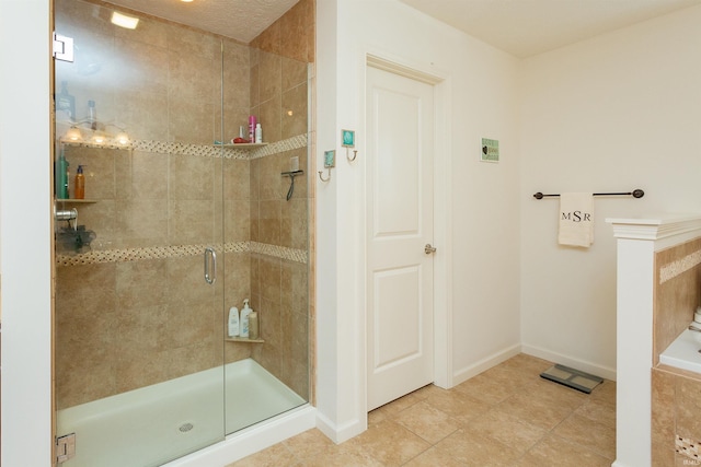 bathroom with tile patterned floors and an enclosed shower