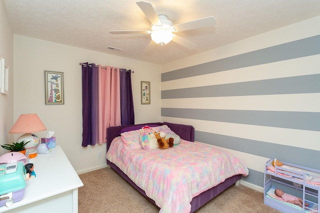 carpeted bedroom with a textured ceiling and ceiling fan