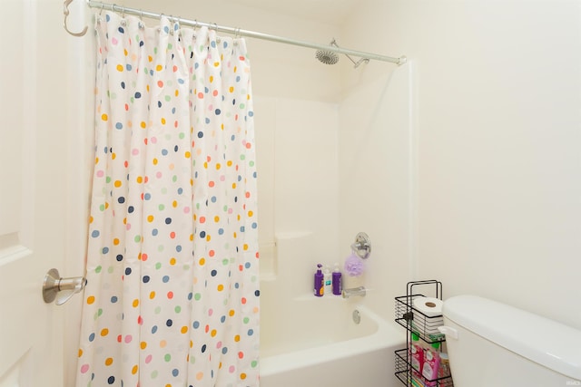 bathroom with shower / bath combo and toilet