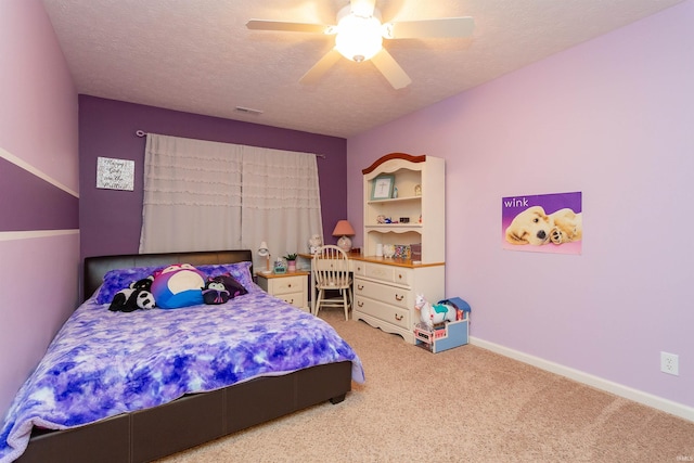 bedroom featuring light carpet, a textured ceiling, and ceiling fan