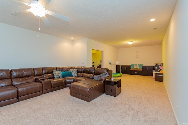 carpeted living room with ceiling fan and a textured ceiling