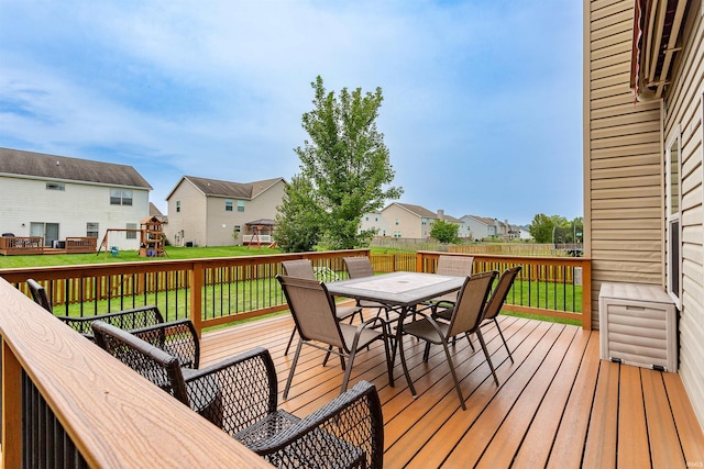 wooden terrace featuring a yard