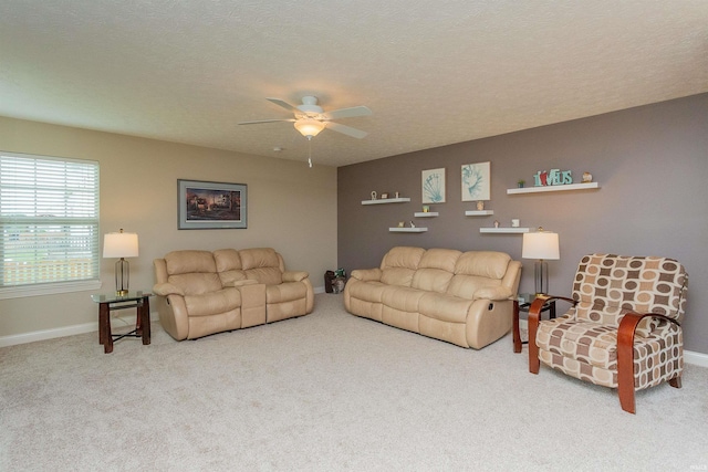 living room with carpet flooring, ceiling fan, and a textured ceiling