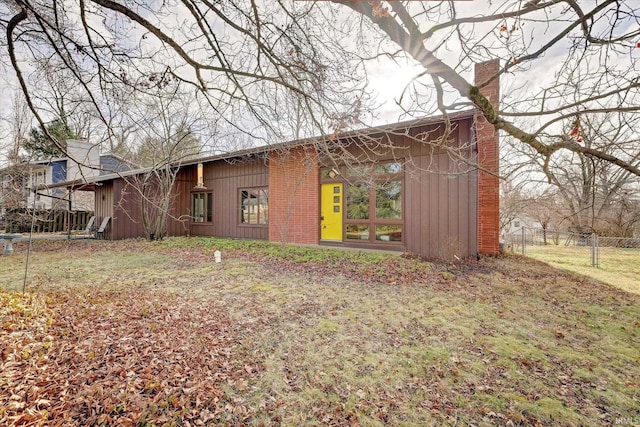 rear view of house featuring a lawn