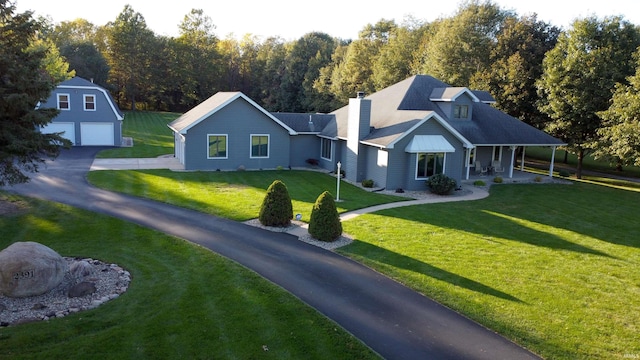 view of front of property with a front lawn and an outdoor structure