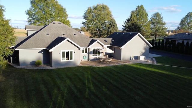 back of property featuring central air condition unit, a patio area, and a yard