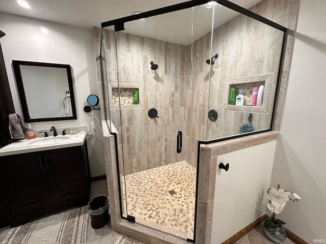 bathroom with vanity, tile patterned floors, and a shower with shower door