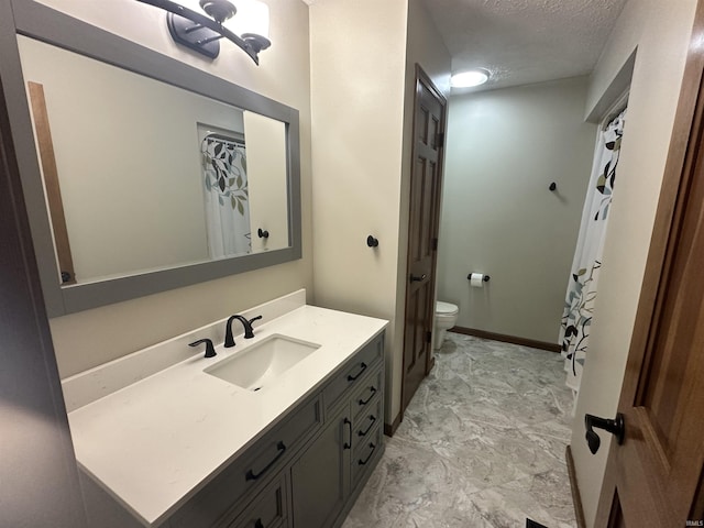 bathroom with vanity, a textured ceiling, and toilet