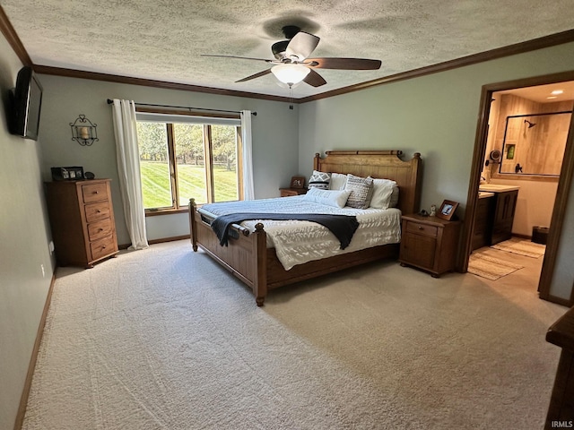 carpeted bedroom with ensuite bath, ceiling fan, a textured ceiling, and ornamental molding