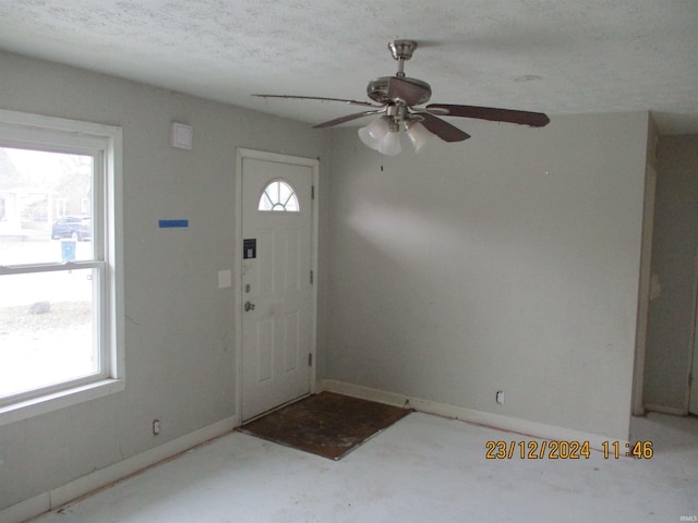 entryway featuring a textured ceiling and ceiling fan