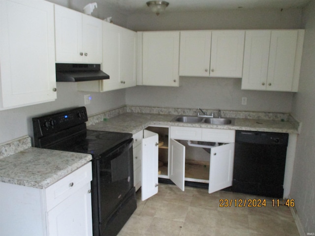 kitchen with sink, black appliances, and white cabinets