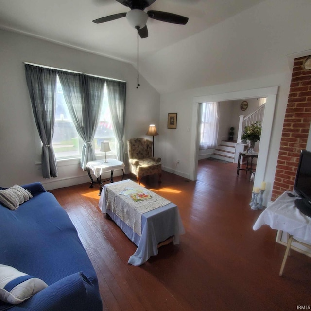 living room with hardwood / wood-style flooring, ceiling fan, and lofted ceiling