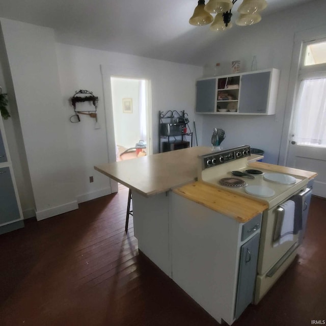 kitchen featuring a kitchen breakfast bar, white electric stove, white cabinets, dark hardwood / wood-style floors, and a kitchen island