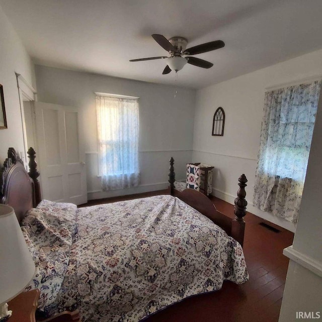 bedroom featuring ceiling fan and dark hardwood / wood-style floors