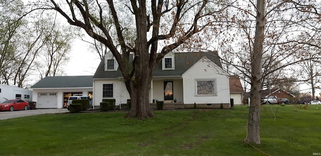 new england style home featuring a garage and a front lawn