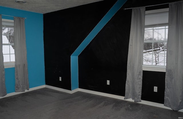 carpeted spare room with a textured ceiling