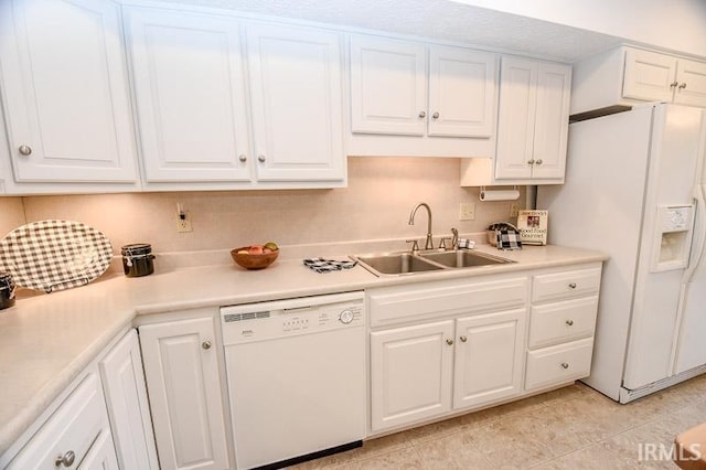 kitchen with white cabinets, white appliances, and sink