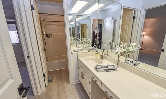 bathroom with vanity, shower / bathing tub combination, and hardwood / wood-style flooring