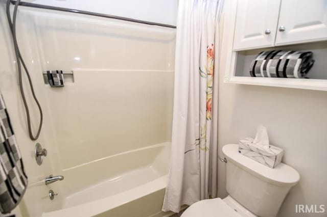 bathroom with toilet and shower / bath combo with shower curtain