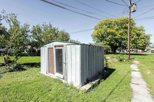 view of outbuilding featuring a lawn