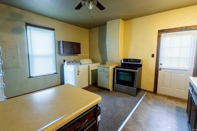 kitchen with dark brown cabinets, ceiling fan, washer and clothes dryer, and electric stove