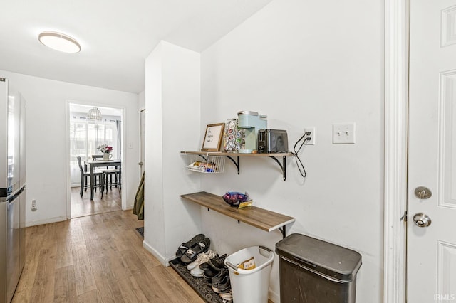 corridor with light hardwood / wood-style flooring