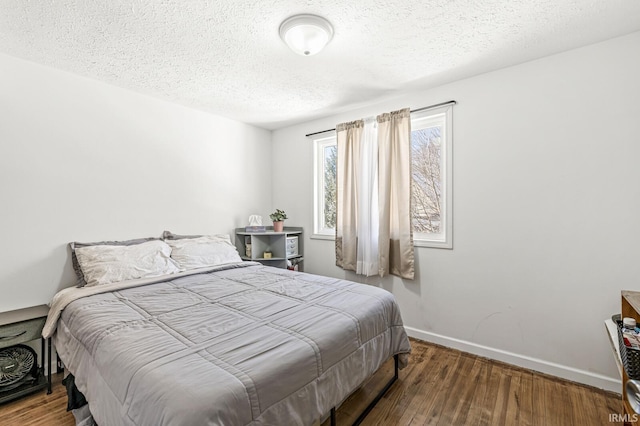 bedroom featuring hardwood / wood-style floors and a textured ceiling