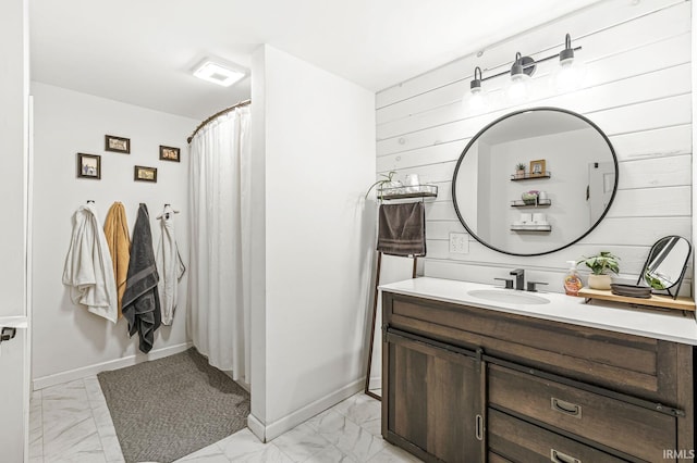 bathroom with vanity and wooden walls