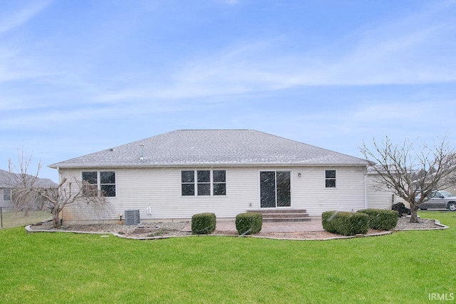 back of house featuring a yard and central AC