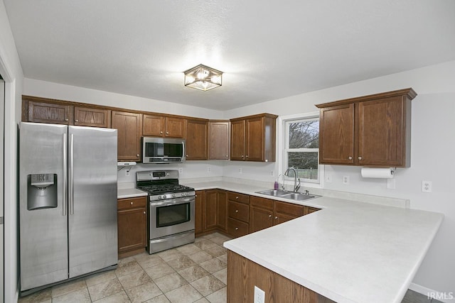 kitchen with sink, kitchen peninsula, and stainless steel appliances