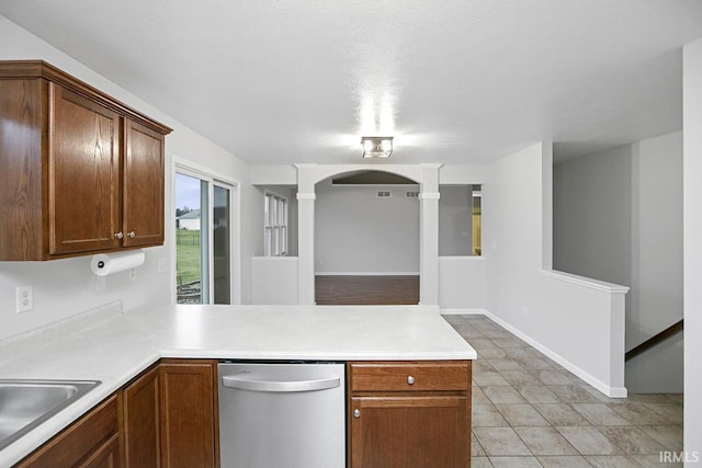 kitchen with dishwasher, sink, decorative columns, kitchen peninsula, and light tile patterned flooring