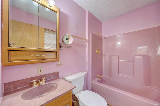 full bathroom with vanity, toilet, washtub / shower combination, and a textured ceiling