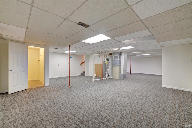 basement featuring heating unit, a drop ceiling, and carpet