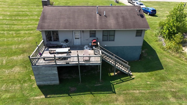 rear view of house featuring a yard and a wooden deck