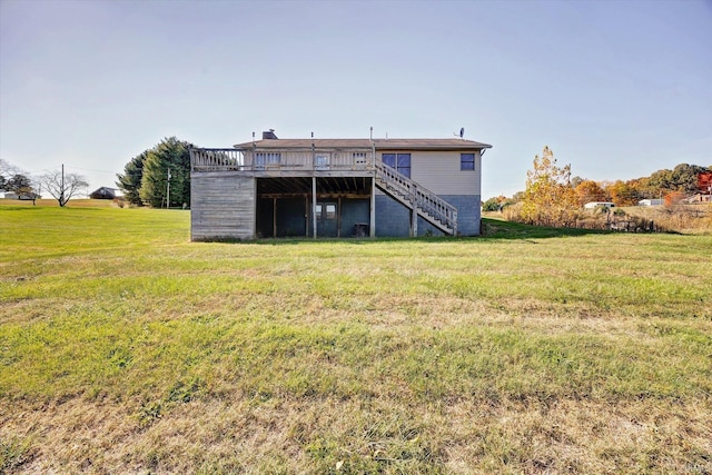 rear view of house with a lawn and a deck