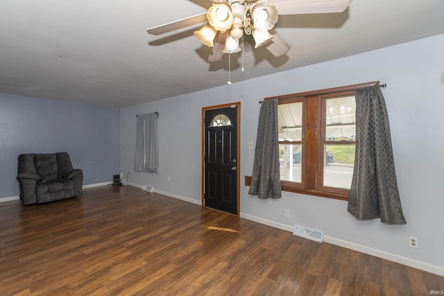 interior space with ceiling fan and dark wood-type flooring