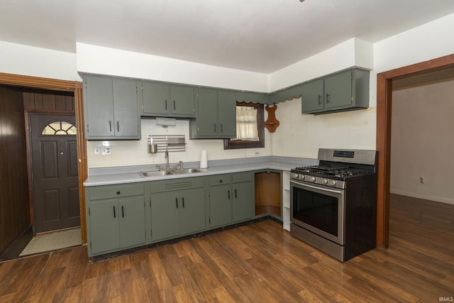 kitchen featuring dark hardwood / wood-style flooring, tasteful backsplash, gas range, sink, and green cabinets