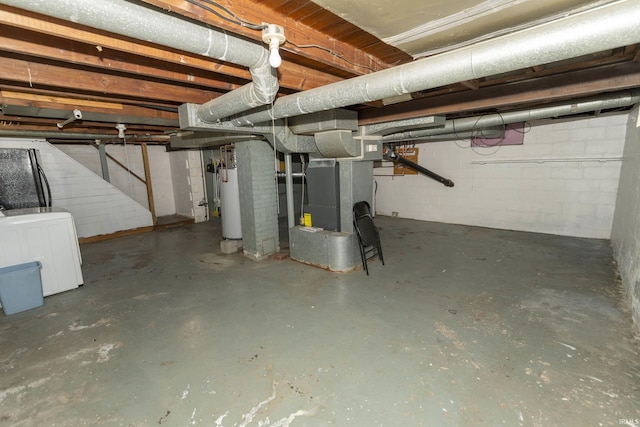 basement featuring water heater and washer / dryer