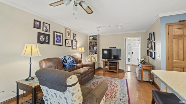 living room with hardwood / wood-style floors, rail lighting, ceiling fan, and crown molding