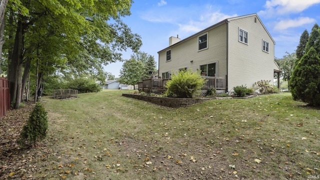 view of side of home with a yard and a deck