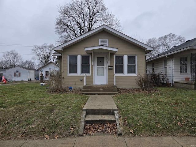 bungalow-style house featuring a front yard