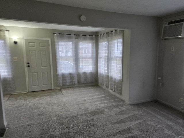 interior space featuring carpet flooring and a wall mounted AC