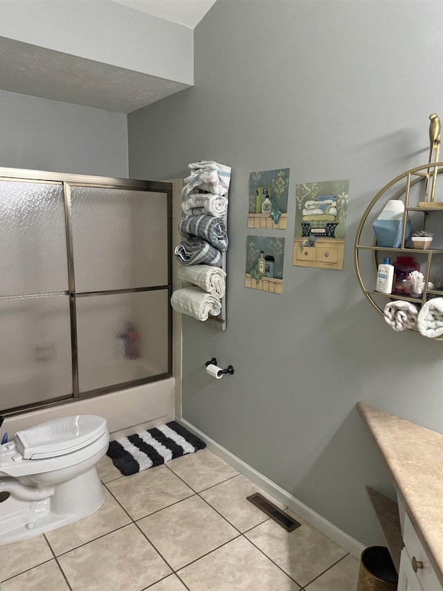 full bathroom with tile patterned flooring, vanity, and combined bath / shower with glass door