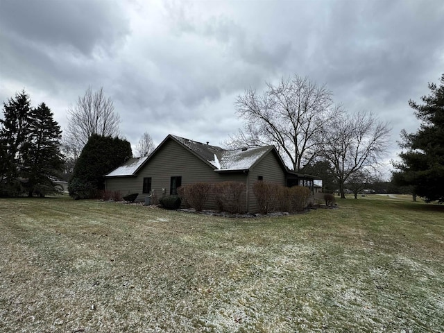 view of home's exterior with a lawn