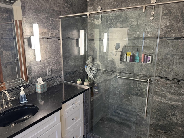 bathroom featuring vanity and tiled shower