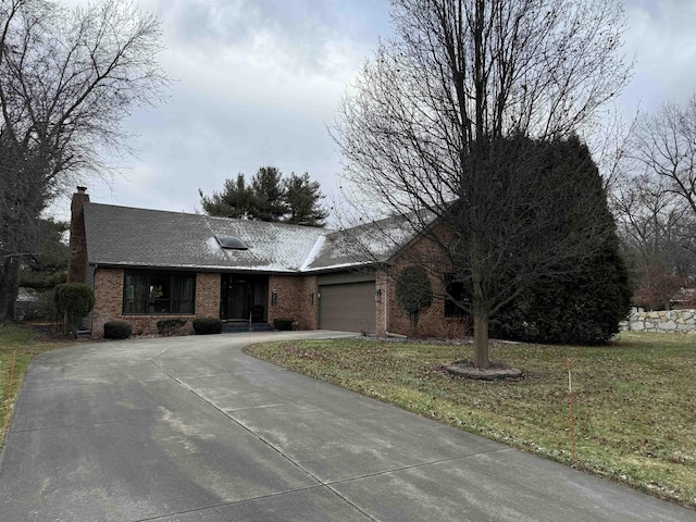 single story home featuring a front yard and a garage