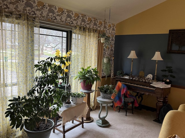 living area with carpet floors and vaulted ceiling