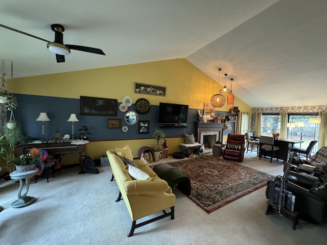 carpeted living room featuring vaulted ceiling and ceiling fan