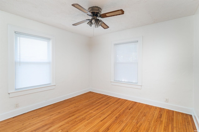 spare room featuring hardwood / wood-style floors, a textured ceiling, plenty of natural light, and ceiling fan