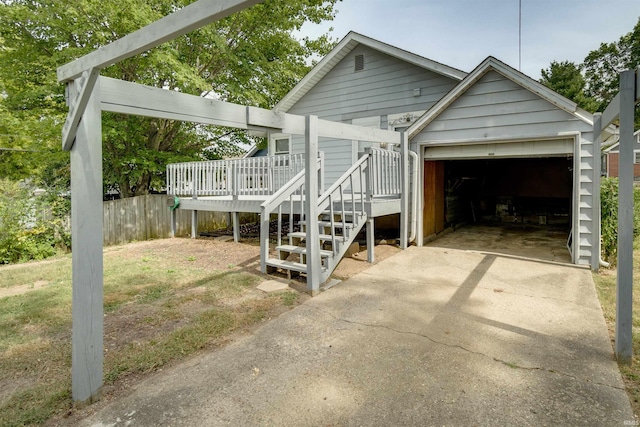 view of front of home featuring a garage and a wooden deck